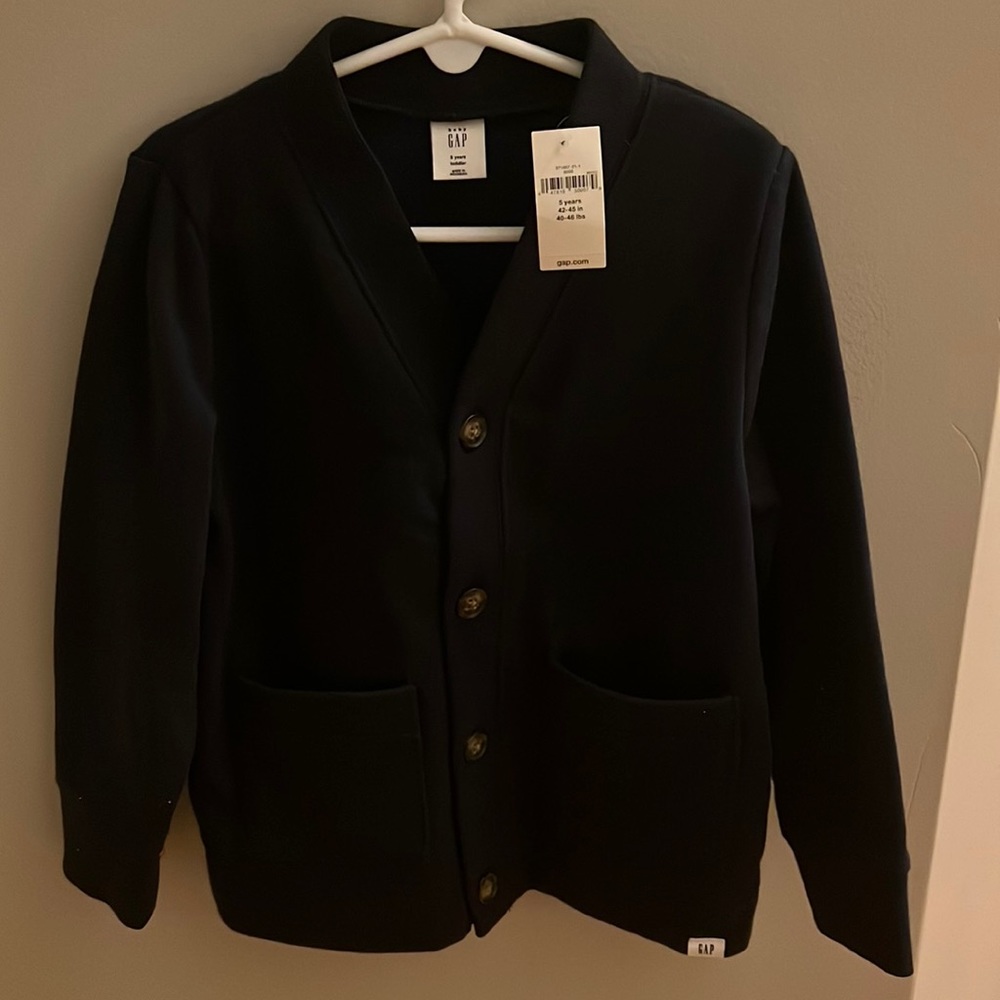 Never worn navy sweatshirt cardigan. Two front pockets. Soft material.